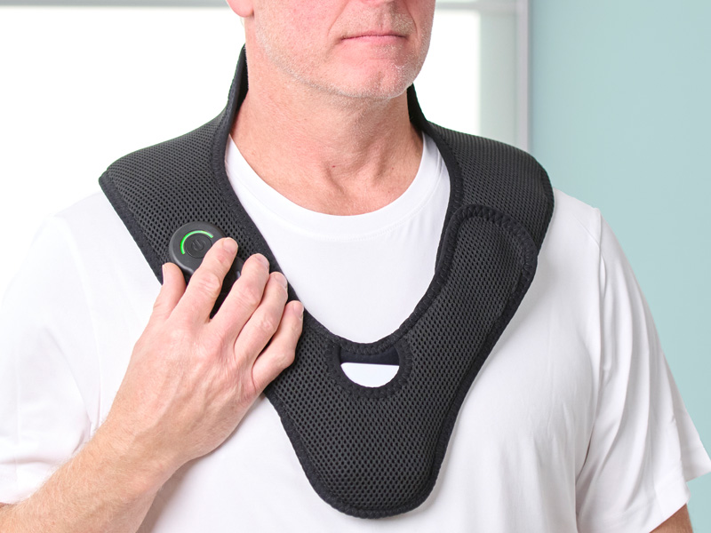 Man wearing the Activ8 Neck device around his neck, pressing a button on the controller.