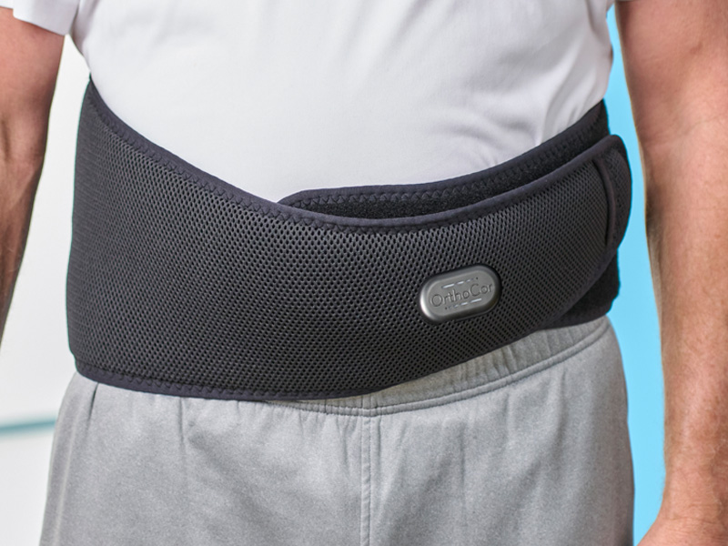 Man wearing the Active Back device around his waist.