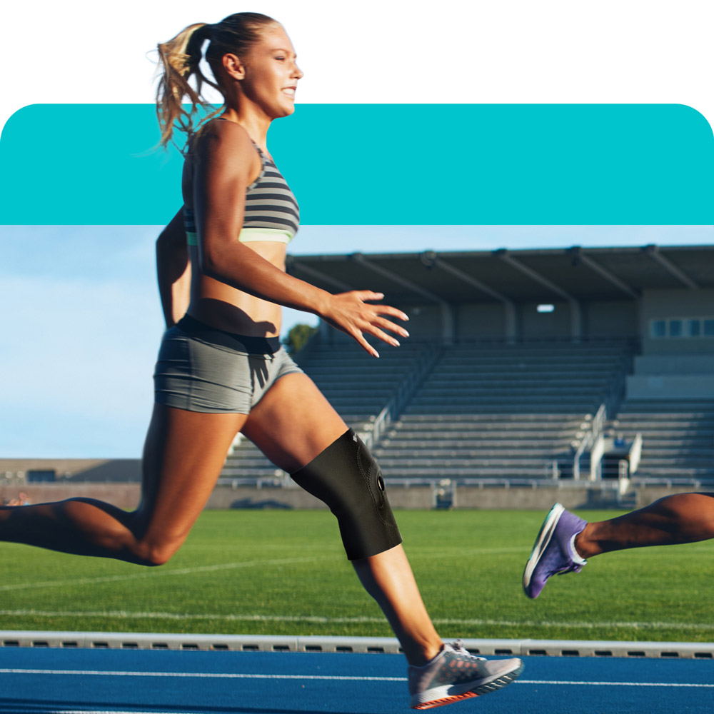 a runner running on a track with a knee brace on