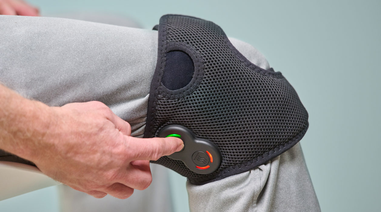 A person wearing an Activ8 System brace to support their knee