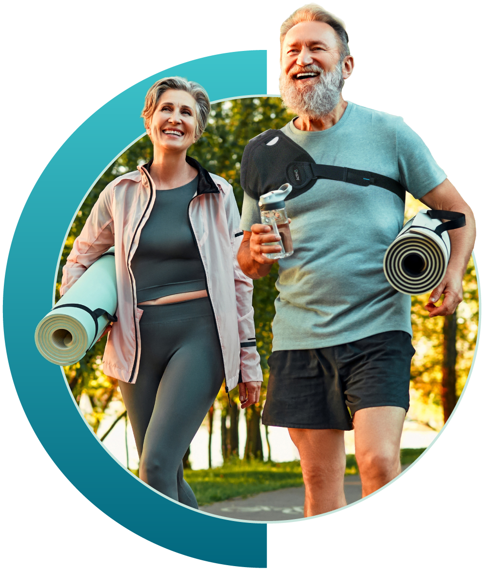 a man and woman walking while holding their yoga mats