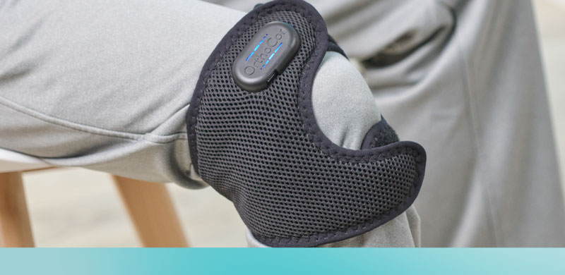 A person wearing an Active System brace around their knee